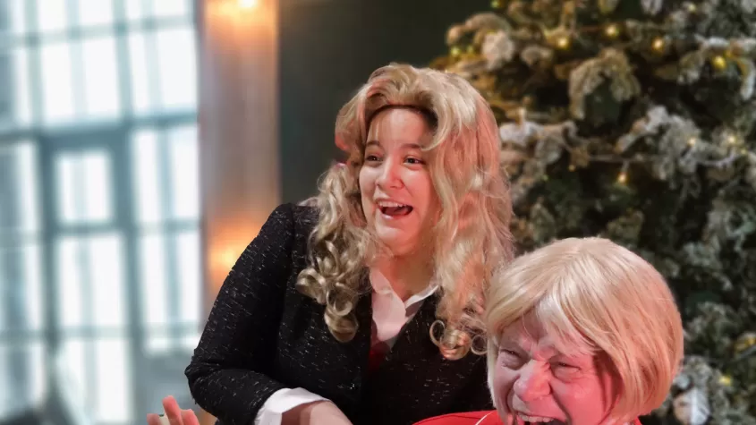 Chris and Christina Crawford screaming in front of a Christmas tree