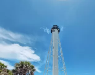 A lighthouse rises above the beach on Boca Grande Outer Islands.